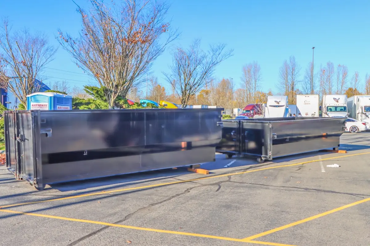 Professional dumpster rental service with roll-off container on residential driveway in Maryville